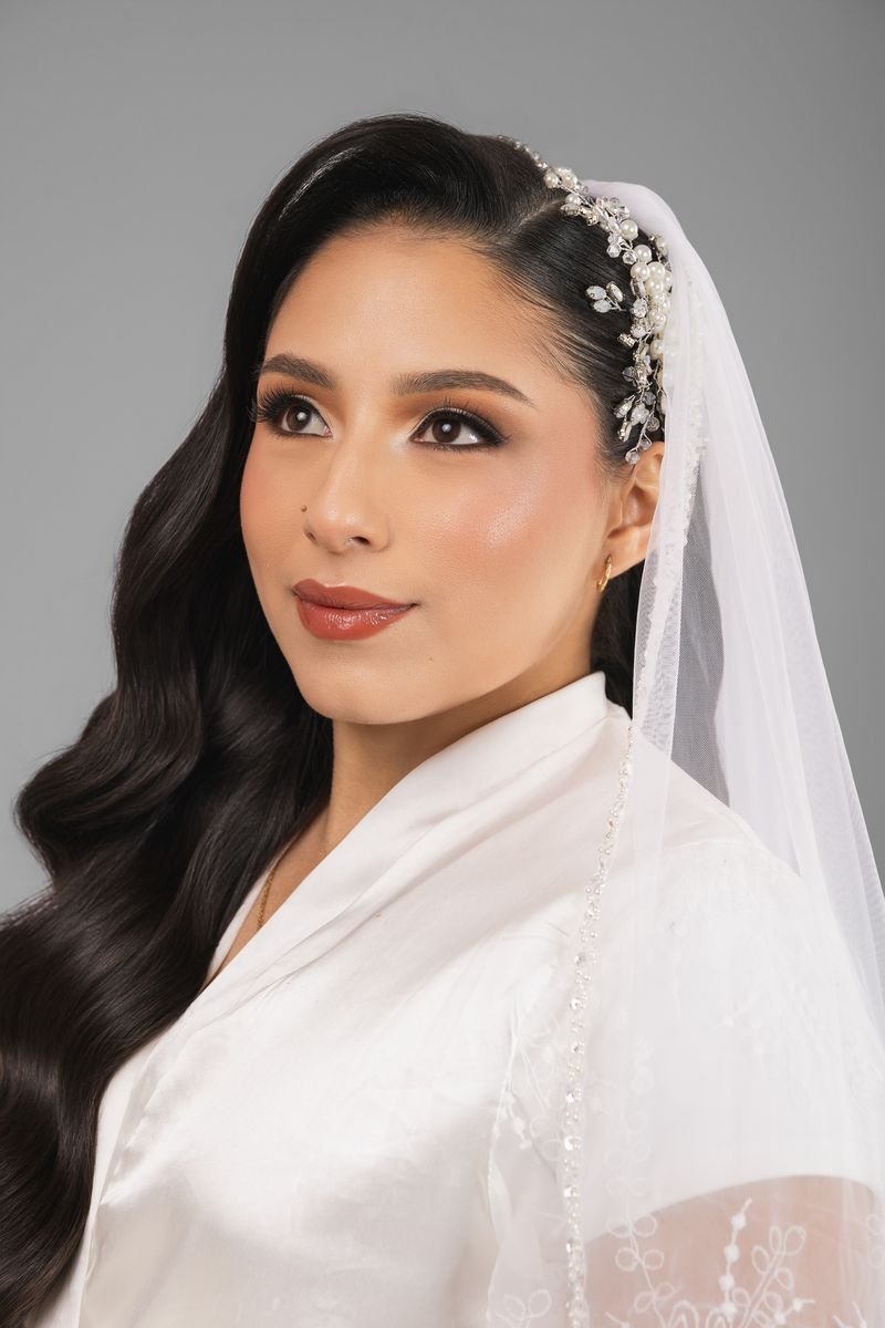 Bridal makeup close-up with veil and pearl hairpiece