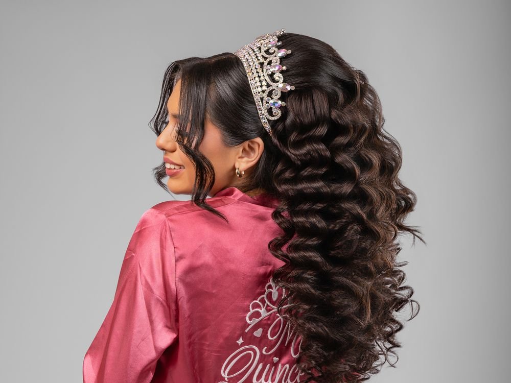 Quinceañera with long defined curls and a crown